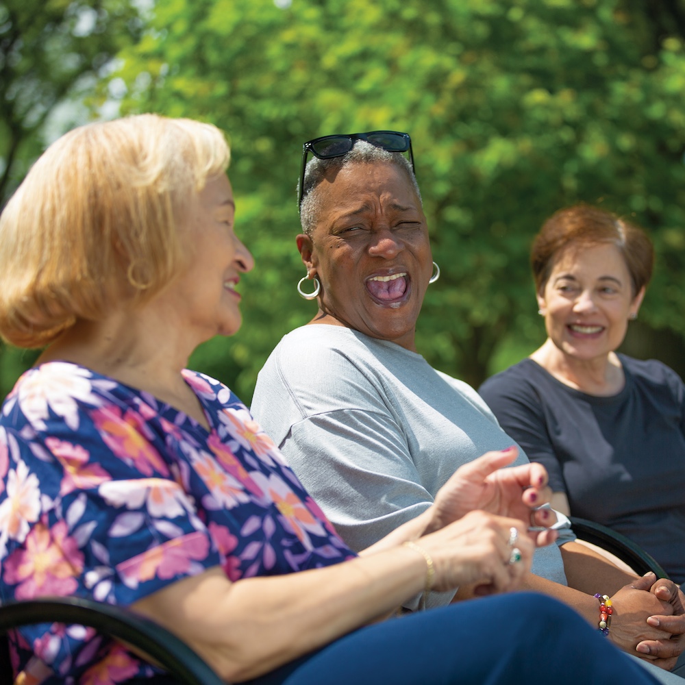 3 elderly women talking outside